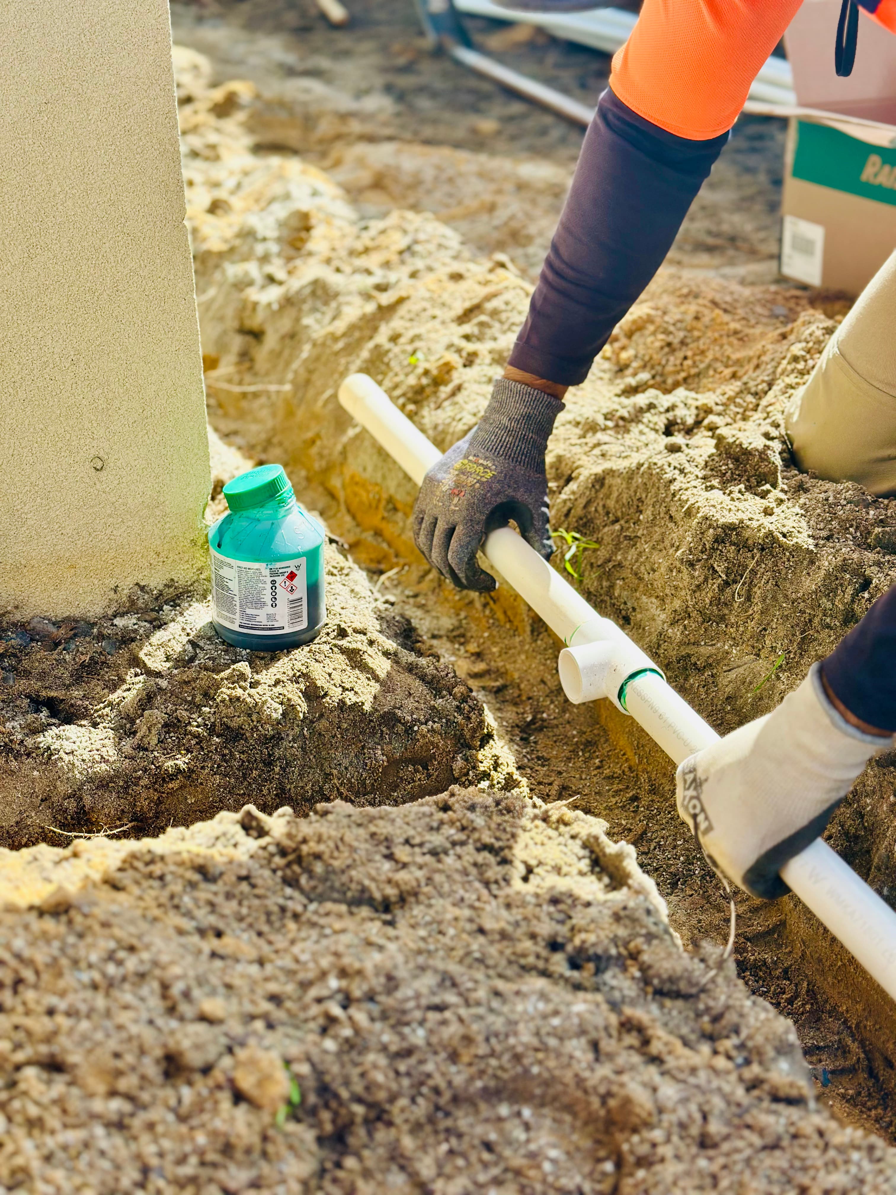 Garden irrigation repair work near soil and plants